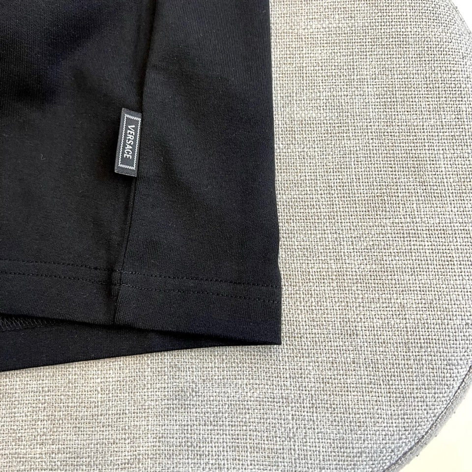 Versace T-shirt size tag, black fabric label on sleeve