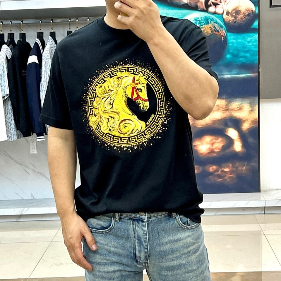 Versace T-shirt on model, black with large gold emblem and horse-lion print