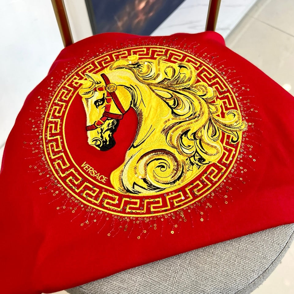 Versace red T-shirt chest graphic: gold Medusa in ornate border