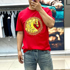 Versace red T-shirt worn by model, gold Medusa crest print