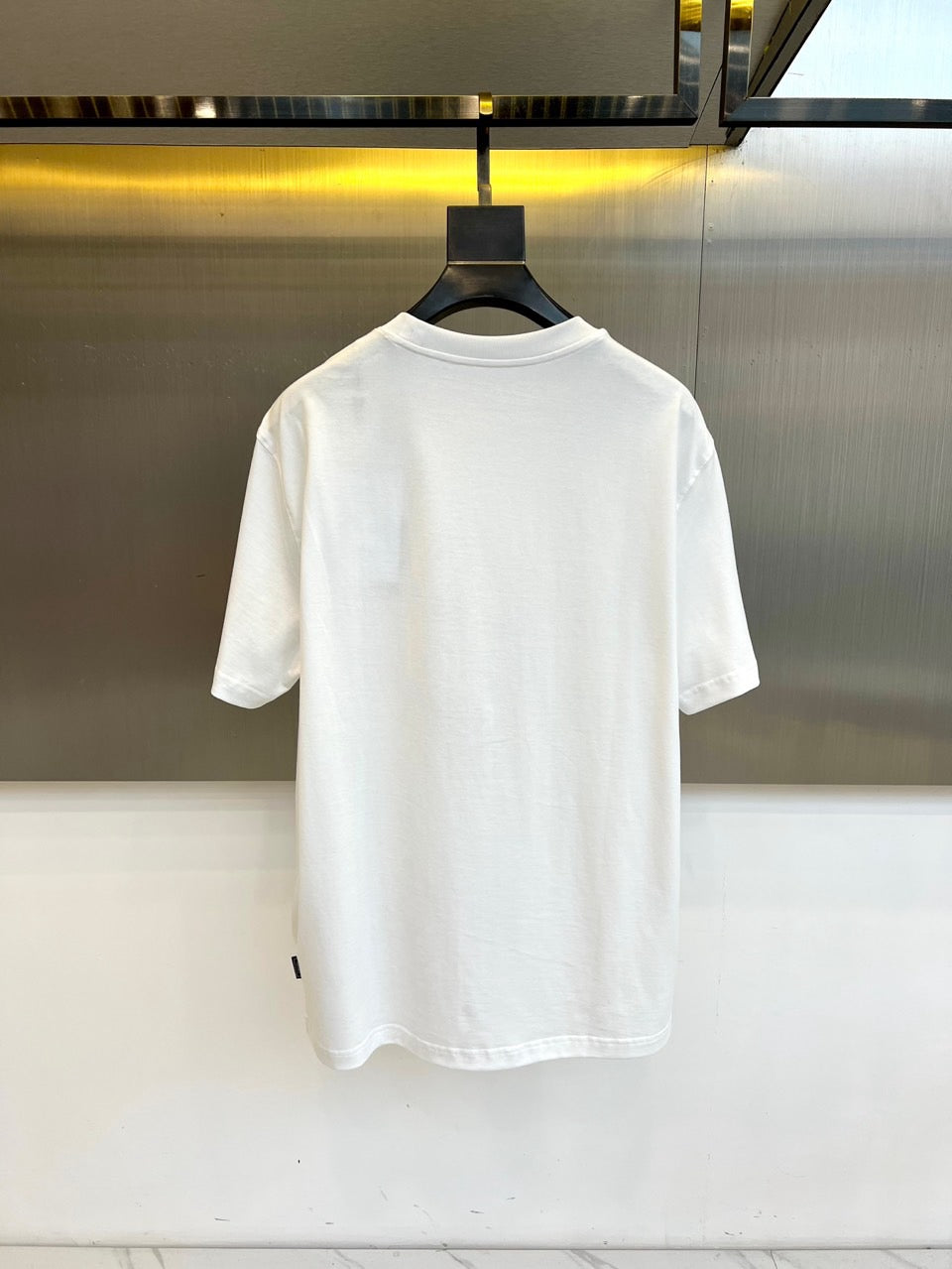 White T-shirt back view on hanger