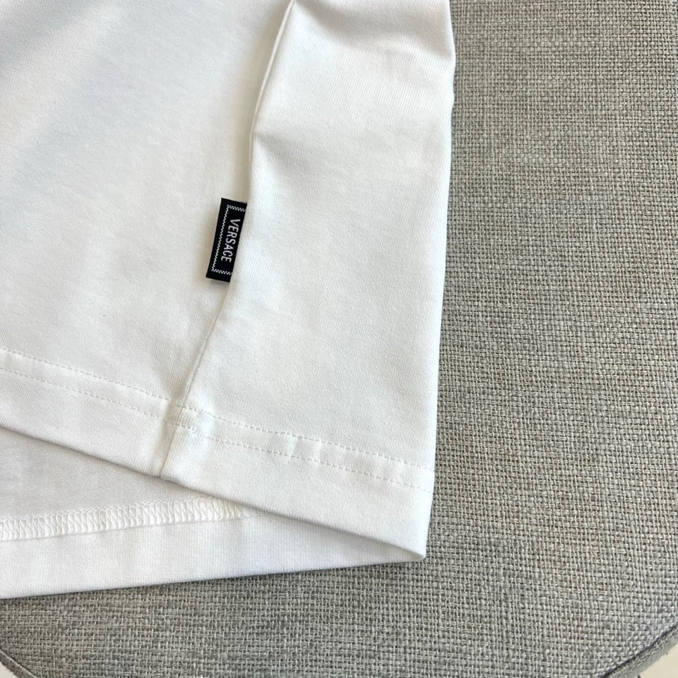 White T-shirt cuff with black Versace neck label