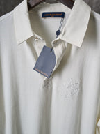 White polo shirt with collar and button placket plus embroidered detail