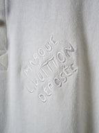 Louis Vuitton embossed script logo on white polo fabric