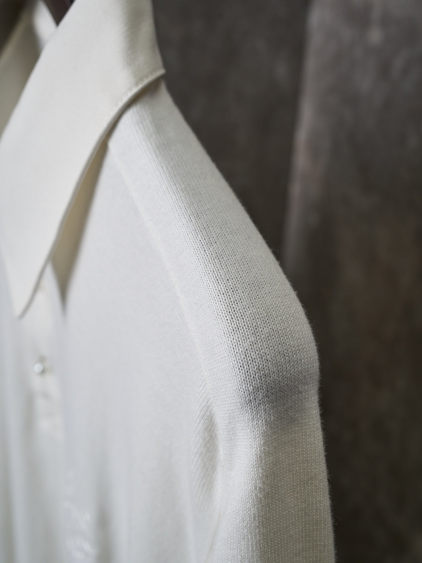 White polo shirt sleeve and side seam close-up