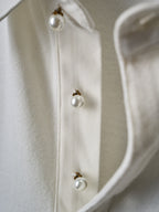 White polo shirt with pearl-look buttons on placket