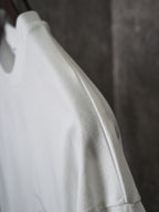 White T-shirt sleeve close-up with knit texture detail