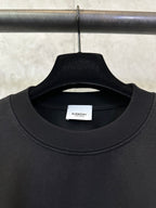 Black crew-neck T-shirt with ribbed collar and inner neck label
