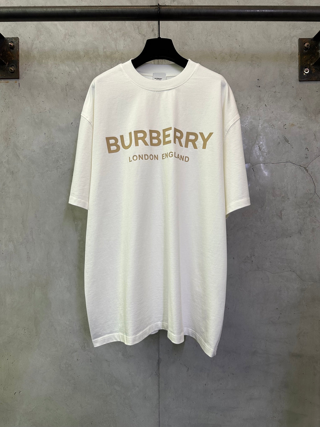 Off-white crewneck T-shirt with Burberry logo and “London England” text on the front