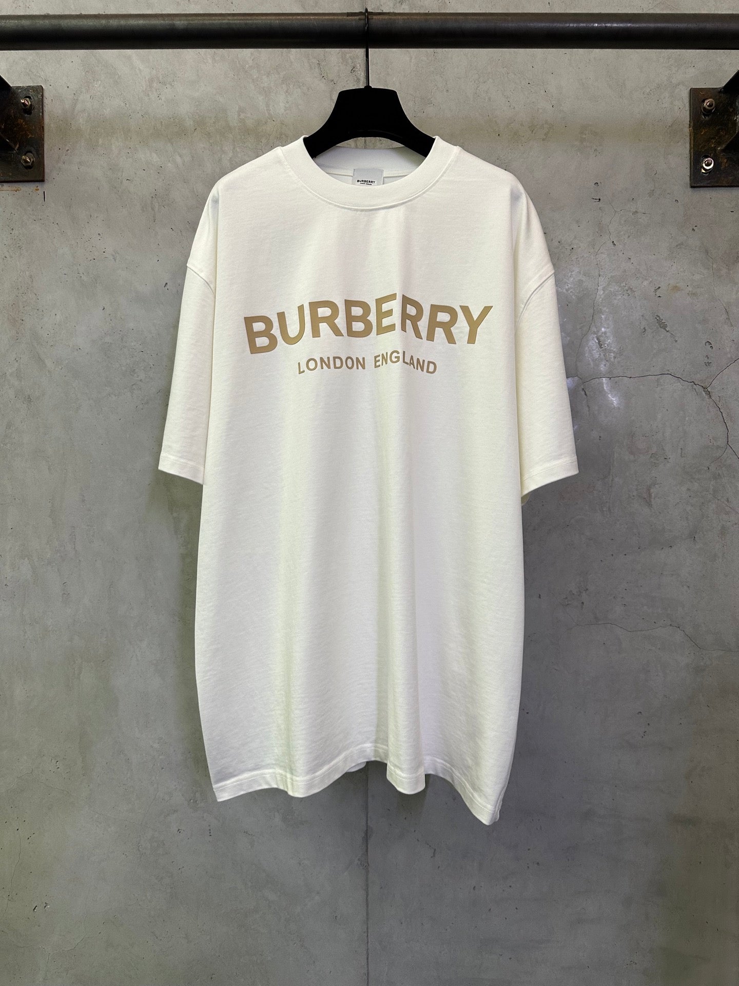 Off-white crewneck T-shirt with Burberry logo and “London England” text on the front