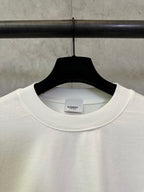 Off-white crewneck T-shirt collar detail with small Burberry logo at the chest
