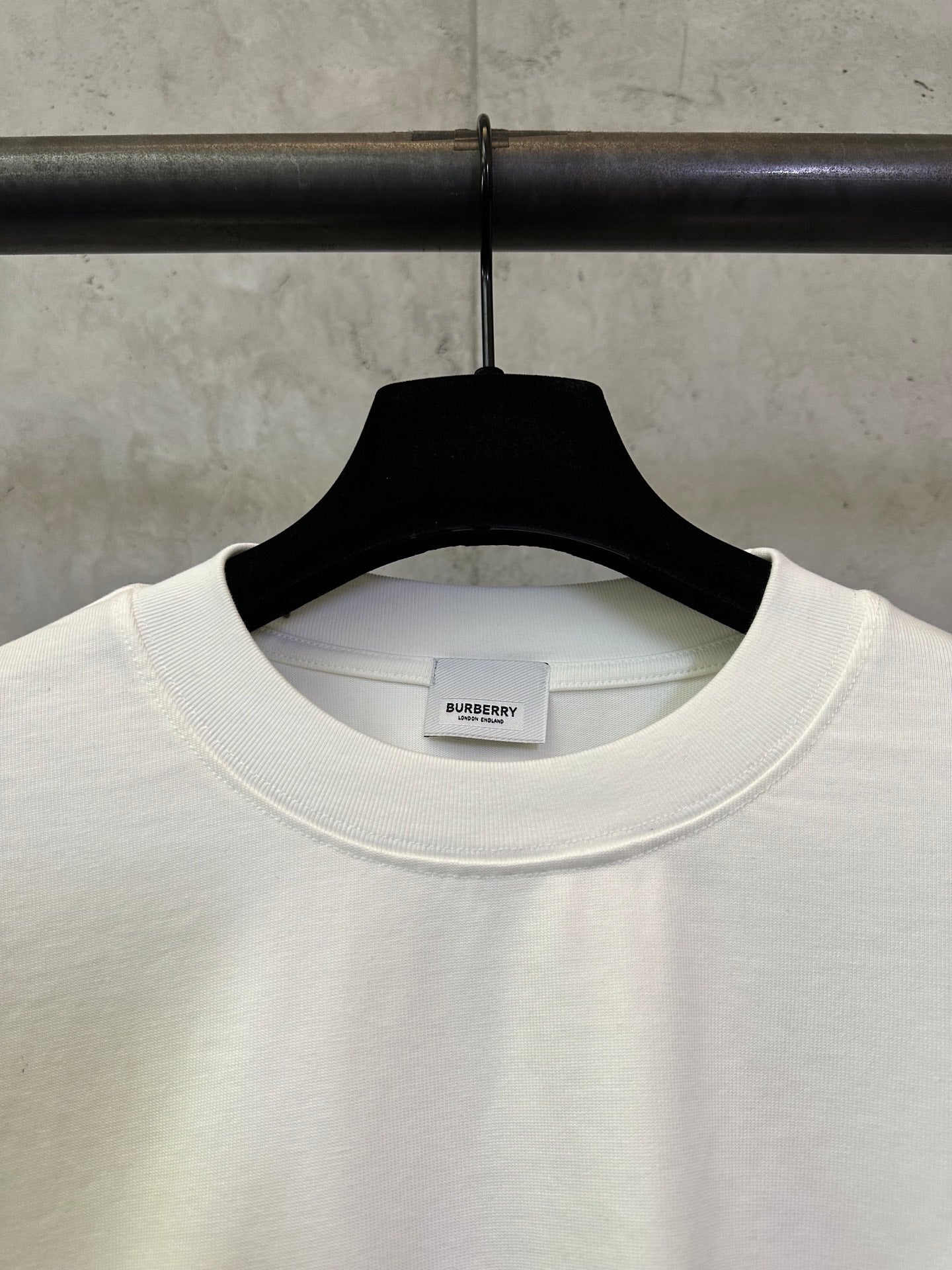 Off-white crewneck T-shirt collar detail with small Burberry logo at the chest