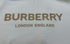 Close-up of off-white T-shirt with Burberry logo and “London England” text