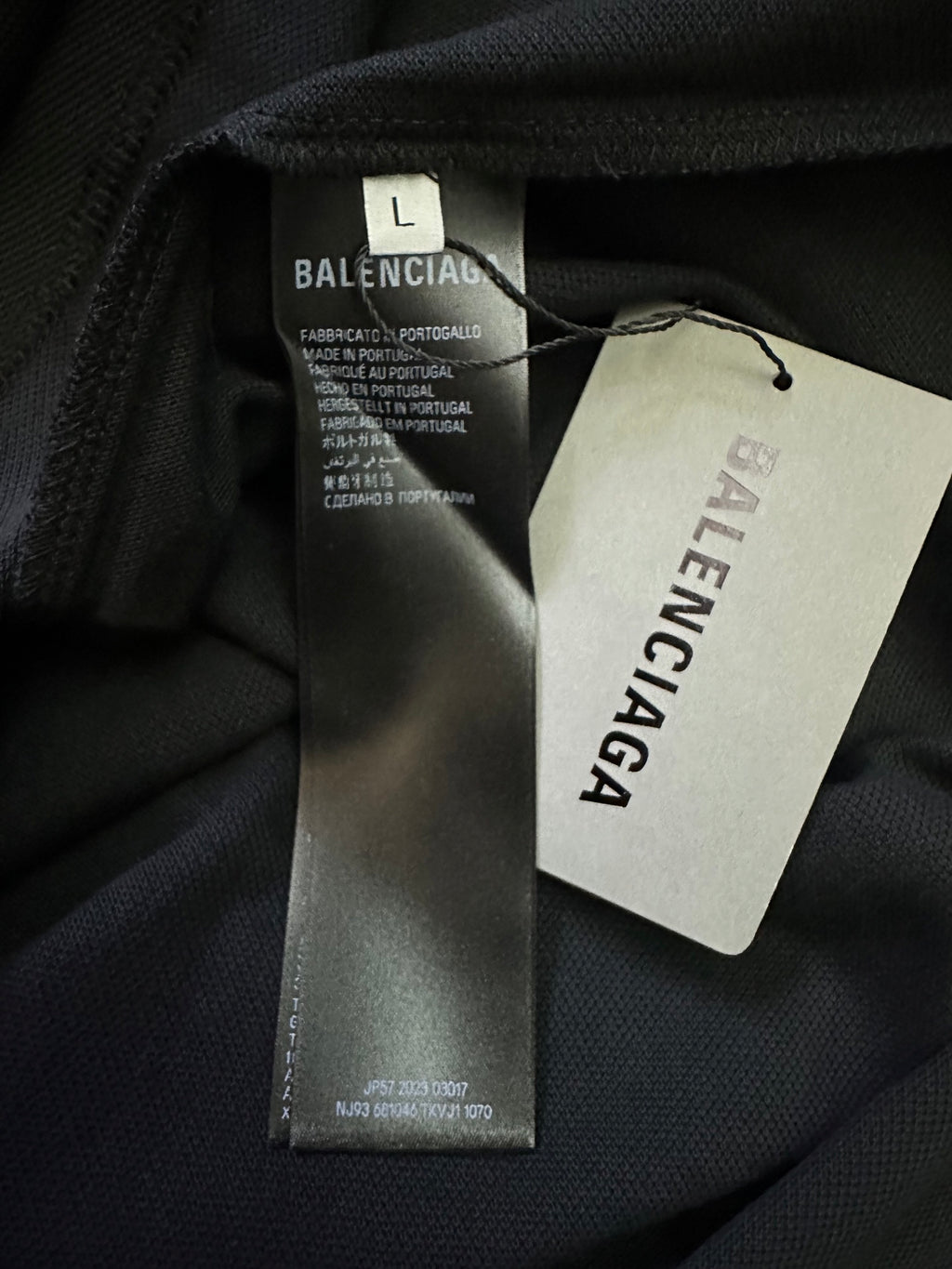 Balenciaga polo shirt neck label and size tag on black fabric