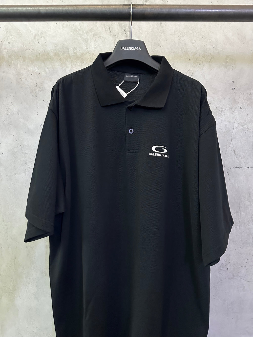 Balenciaga black polo shirt with embroidered chest logo and button placket