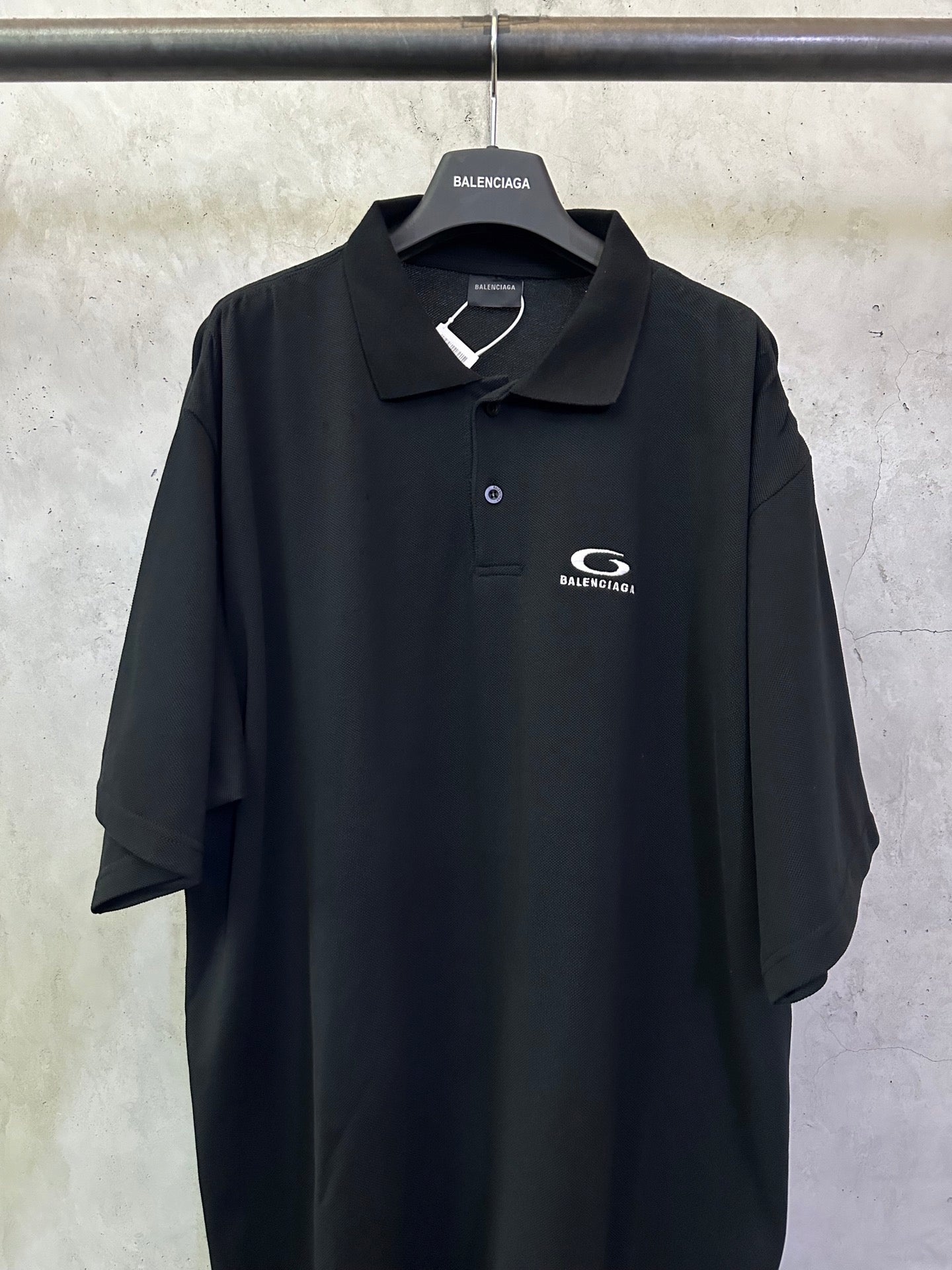 Balenciaga black polo shirt with embroidered chest logo and button placket
