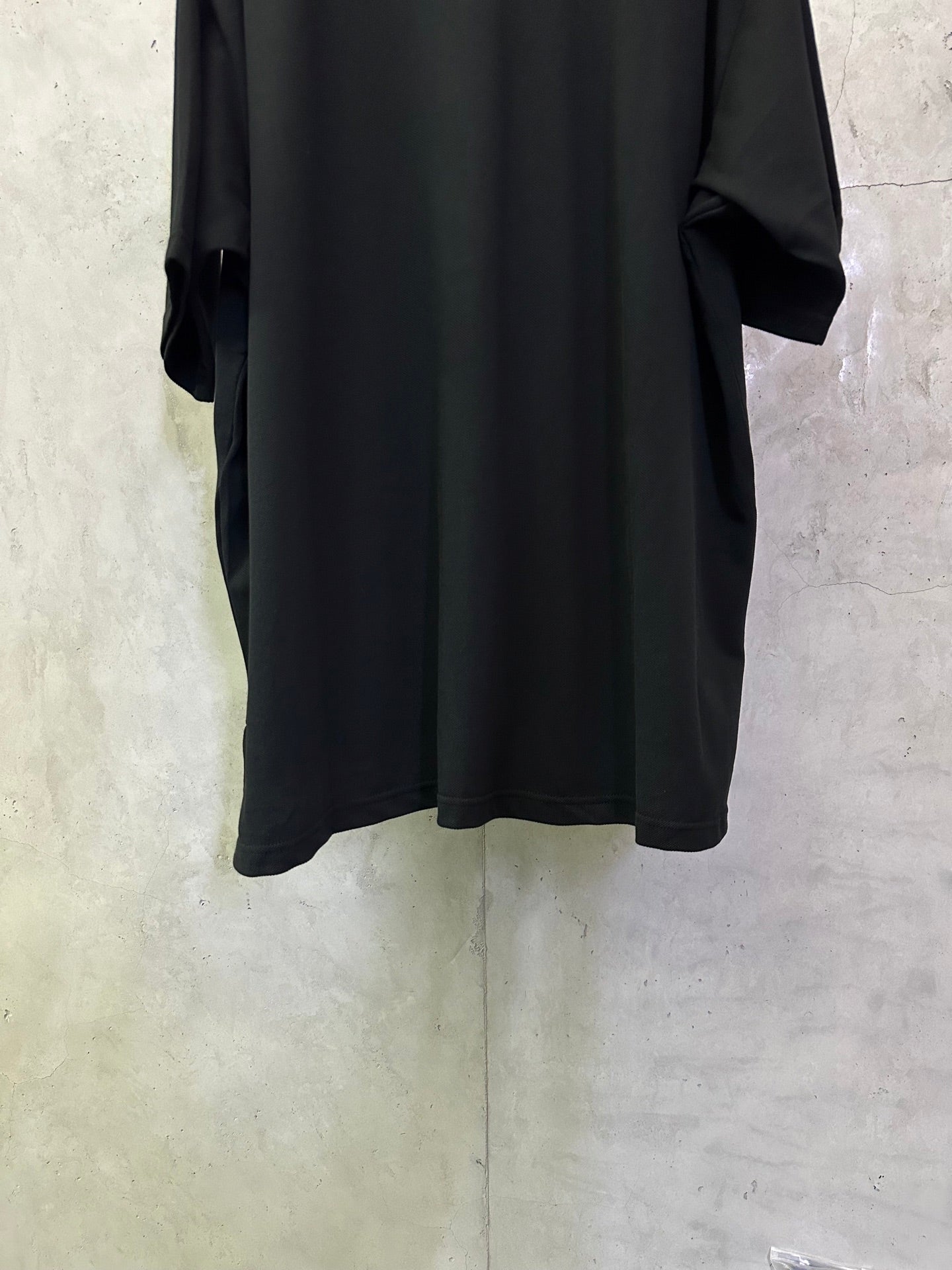 Balenciaga black polo shirt, back view with straight hem and draped short sleeves