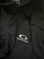 Balenciaga polo shirt fabric close-up with embroidered oval logo on chest