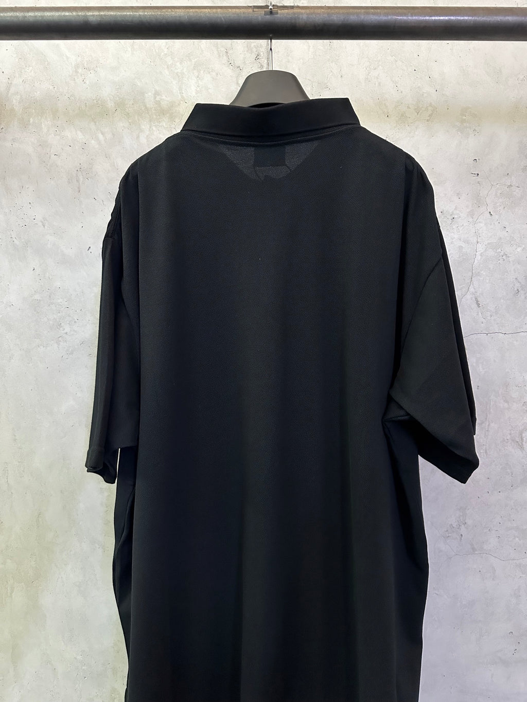 Balenciaga black polo shirt, back view with short sleeves and rounded collar