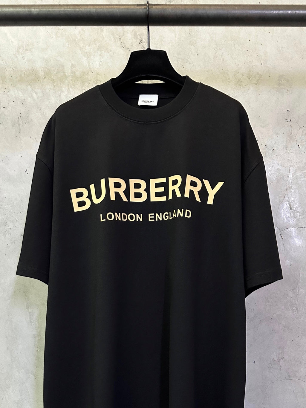 Black Burberry short-sleeve T-shirt with yellow 'BURBERRY' and 'LONDON ENGLAND'