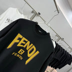 Black short-sleeve T-shirt close-up with yellow FENDI lettering and emblem
