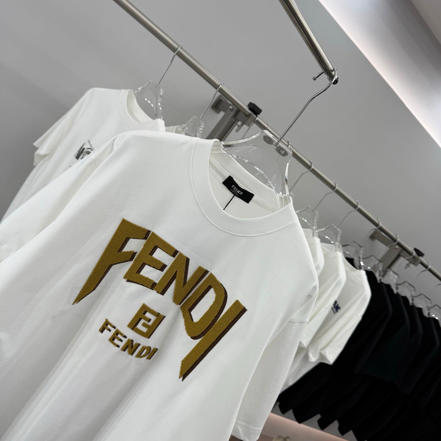 Fendi white short-sleeve T-shirt showing gold FENDI logo detail