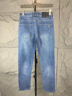 Versace light blue denim jeans front view, belt loops and stitched front pockets