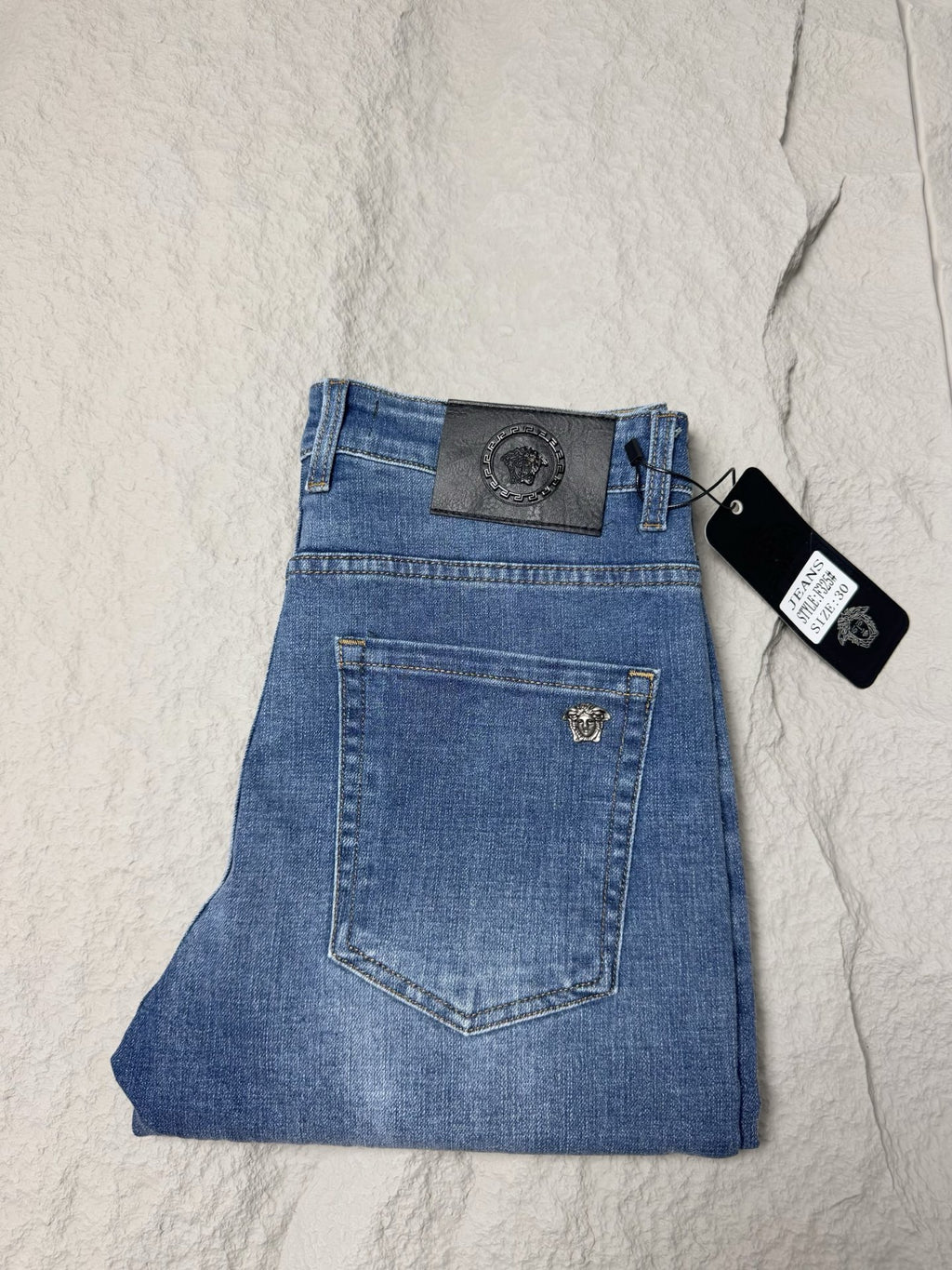 Versace blue denim jeans with waistband patch, belt loops and front zipper fly