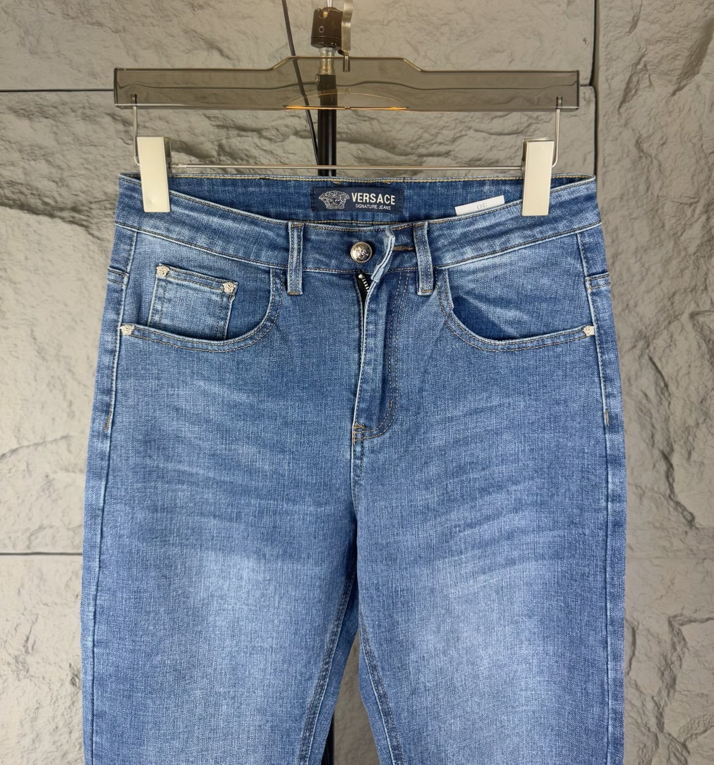 Versace medium blue denim jeans back view with two patch pockets and belt loops