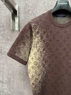 Short-sleeve T-shirt with dark brown body and yellow monogram-style pattern, side view
