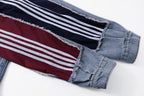 Denim jacket sleeve detail with maroon panel and white striped trim