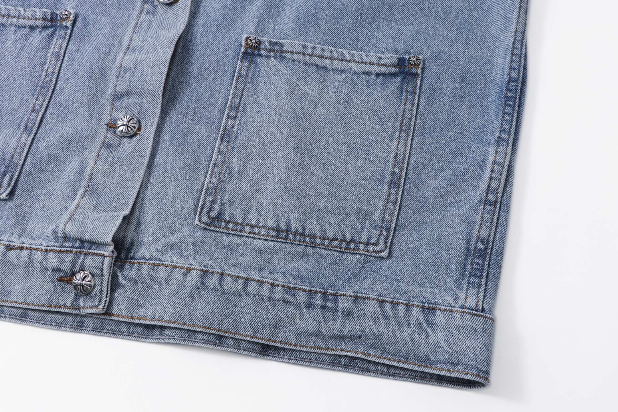 Denim jacket hem and pocket flap with decorative buttons