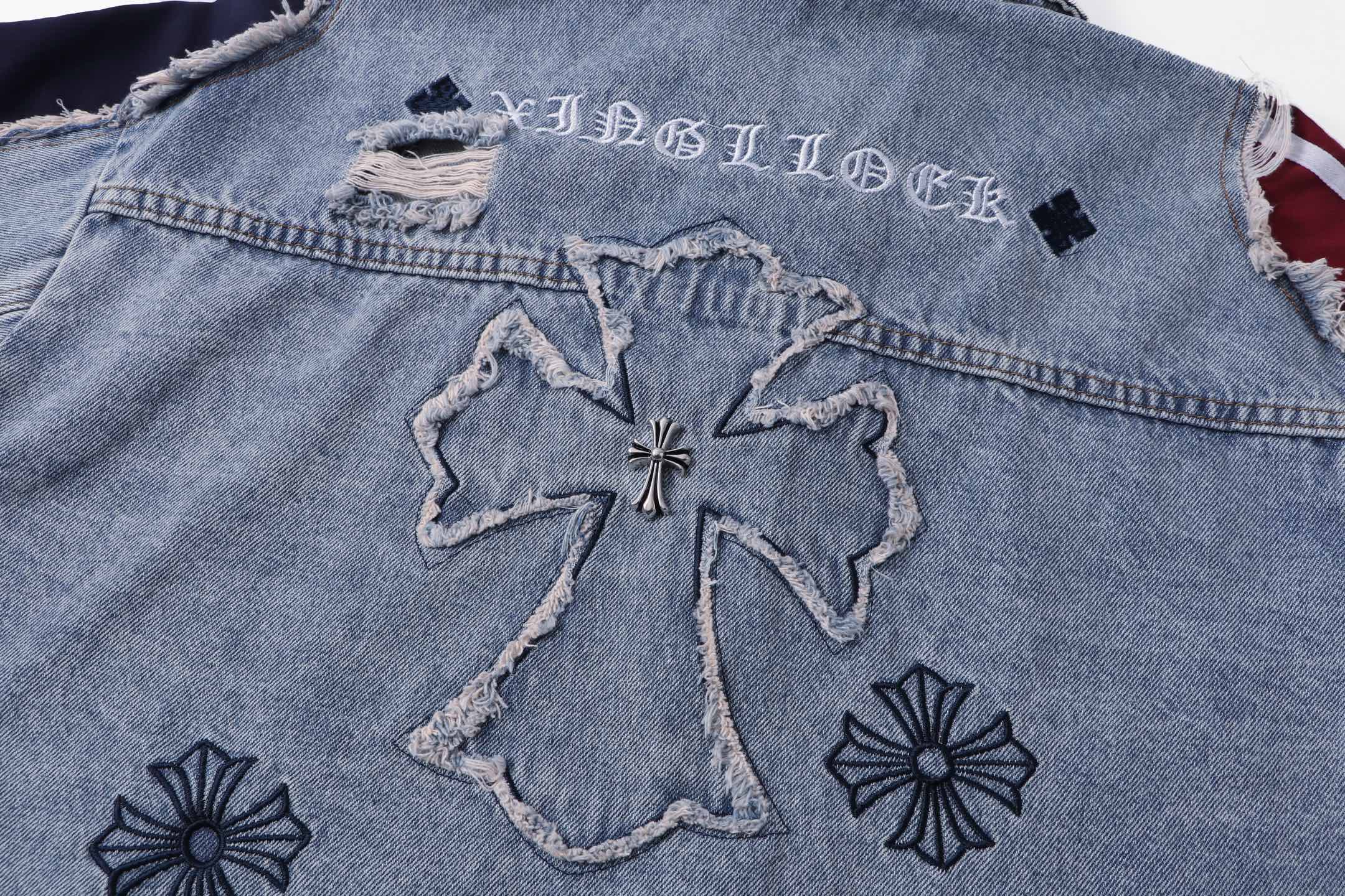 Denim jacket back detail with large cross applique and flower embroidery