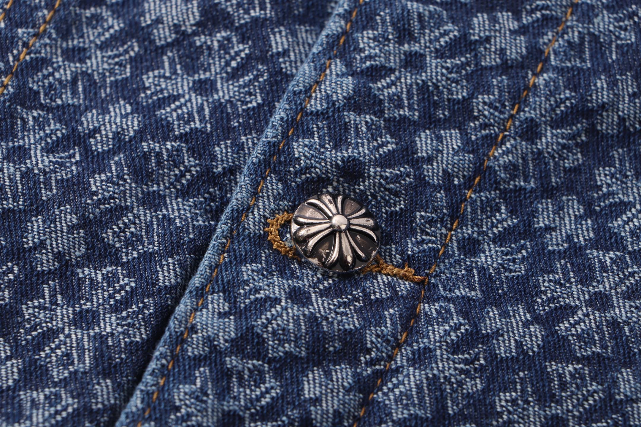 Decorative silver-toned button on dark blue patterned shirt