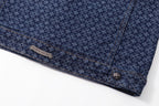 Dark blue patterned shirt front placket with engraved label and decorative button