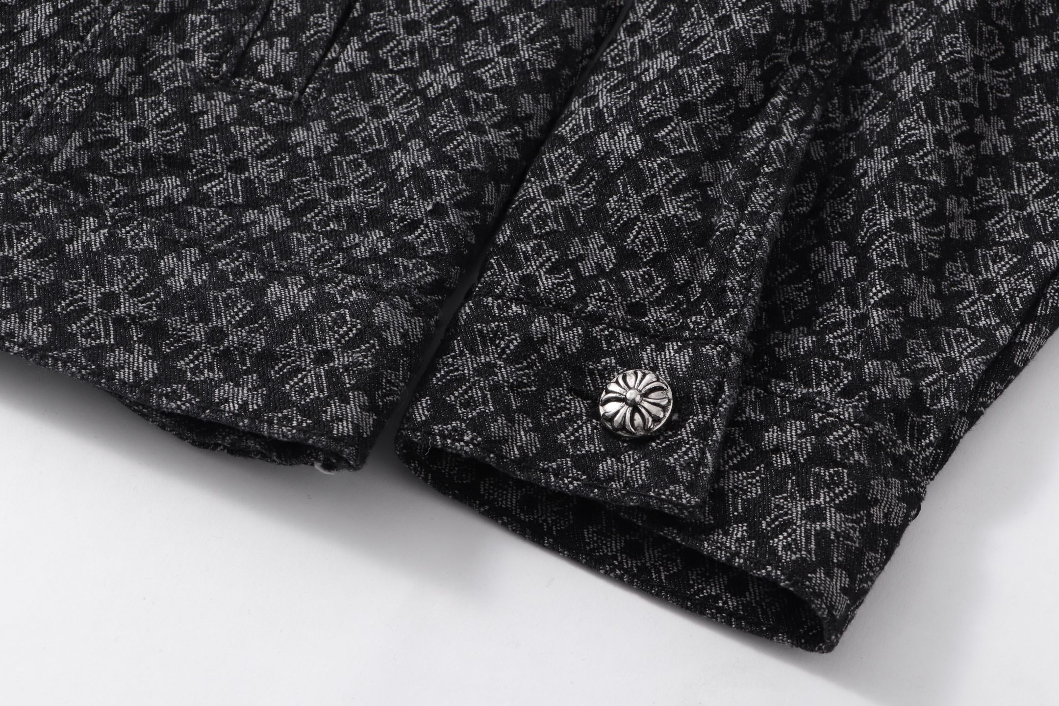 Dark patterned shirt cuff and decorative button detail