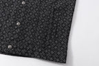 Dark patterned shirt lower front with buttons and curved hem