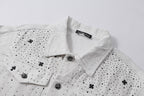 White denim jacket collar and button placket with embroidered cross and dot details