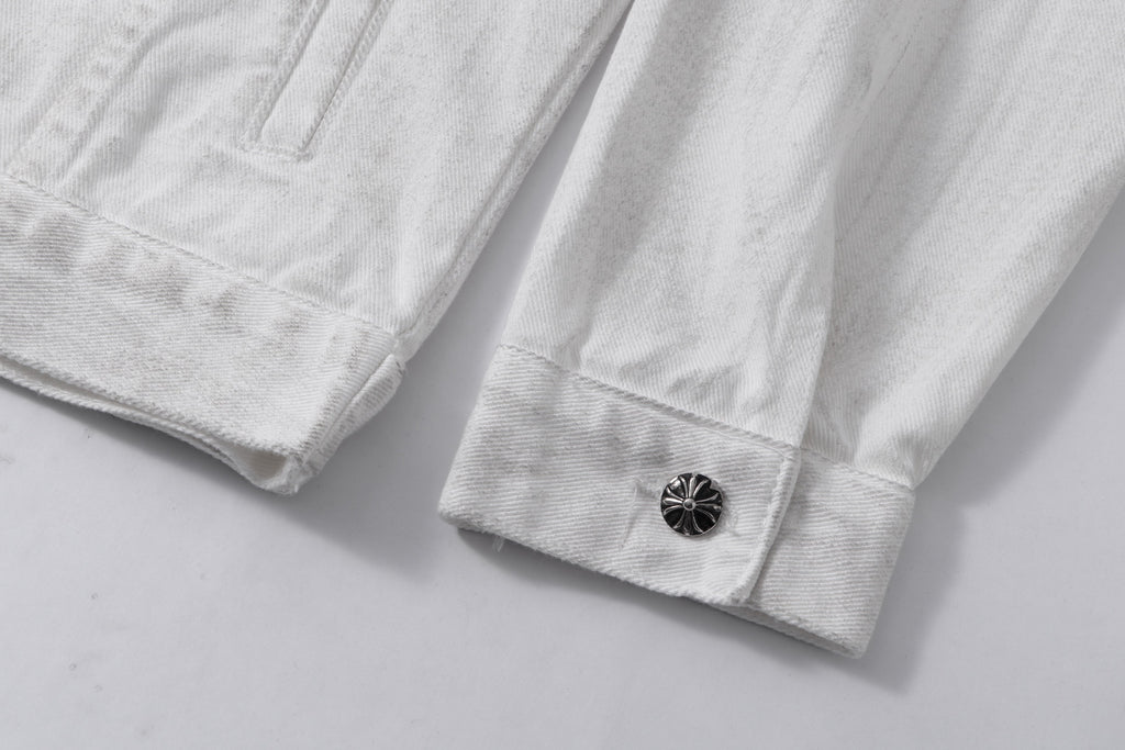White denim jacket sleeve cuff with dark button closure