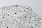 White denim jacket back yoke with embroidered cross and dot pattern