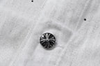 Dark metal button on white denim jacket with ridged floral design