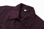 Collar and interior neckline label detail on dark plum long-sleeve jacket