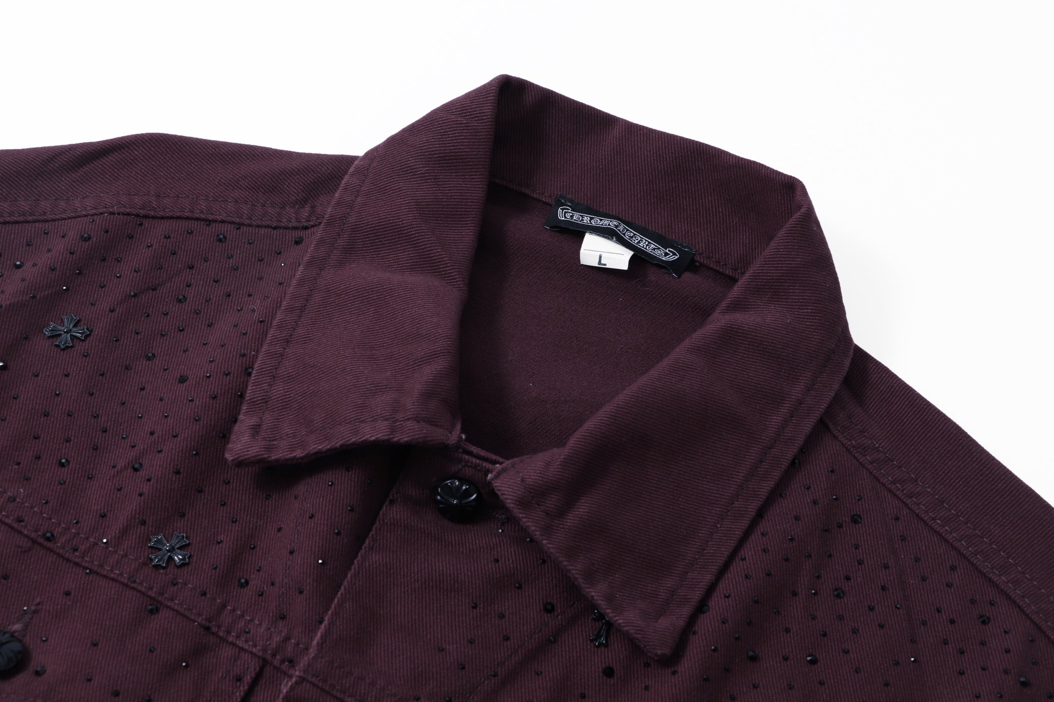 Collar and interior neckline label detail on dark plum long-sleeve jacket