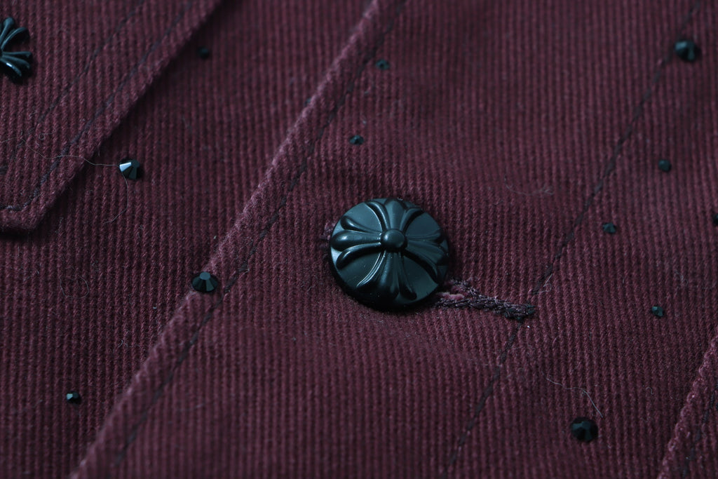 Long-sleeve jacket fabric detail with embroidered speckles and dark button