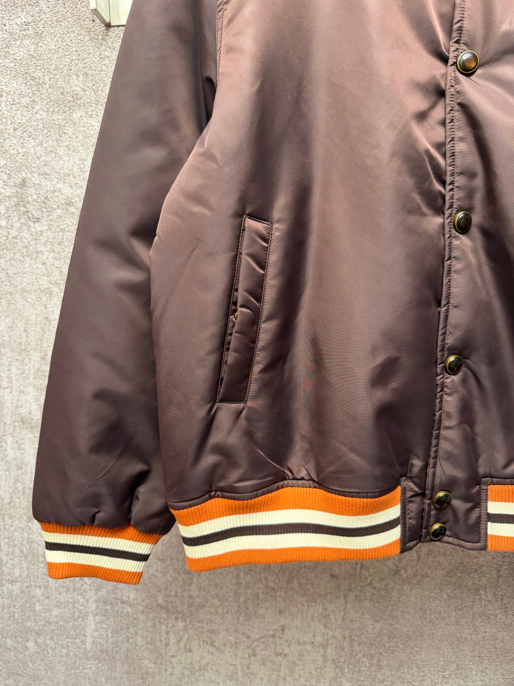 Louis Vuitton long bomber jacket, side view showing padded quilting and striped hem