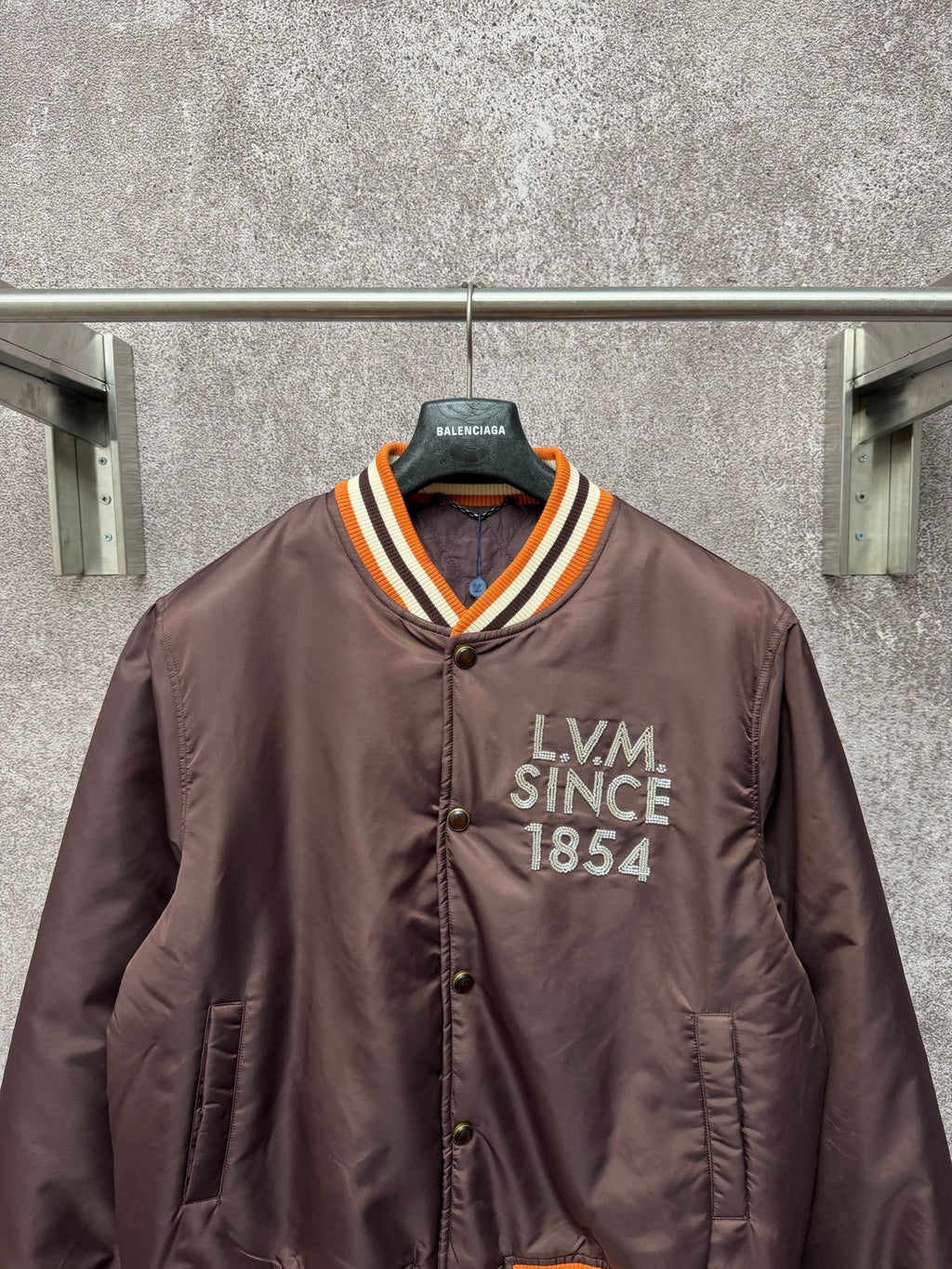 Louis Vuitton long bomber jacket, front view with LV M Since 1854 patch and striped collar