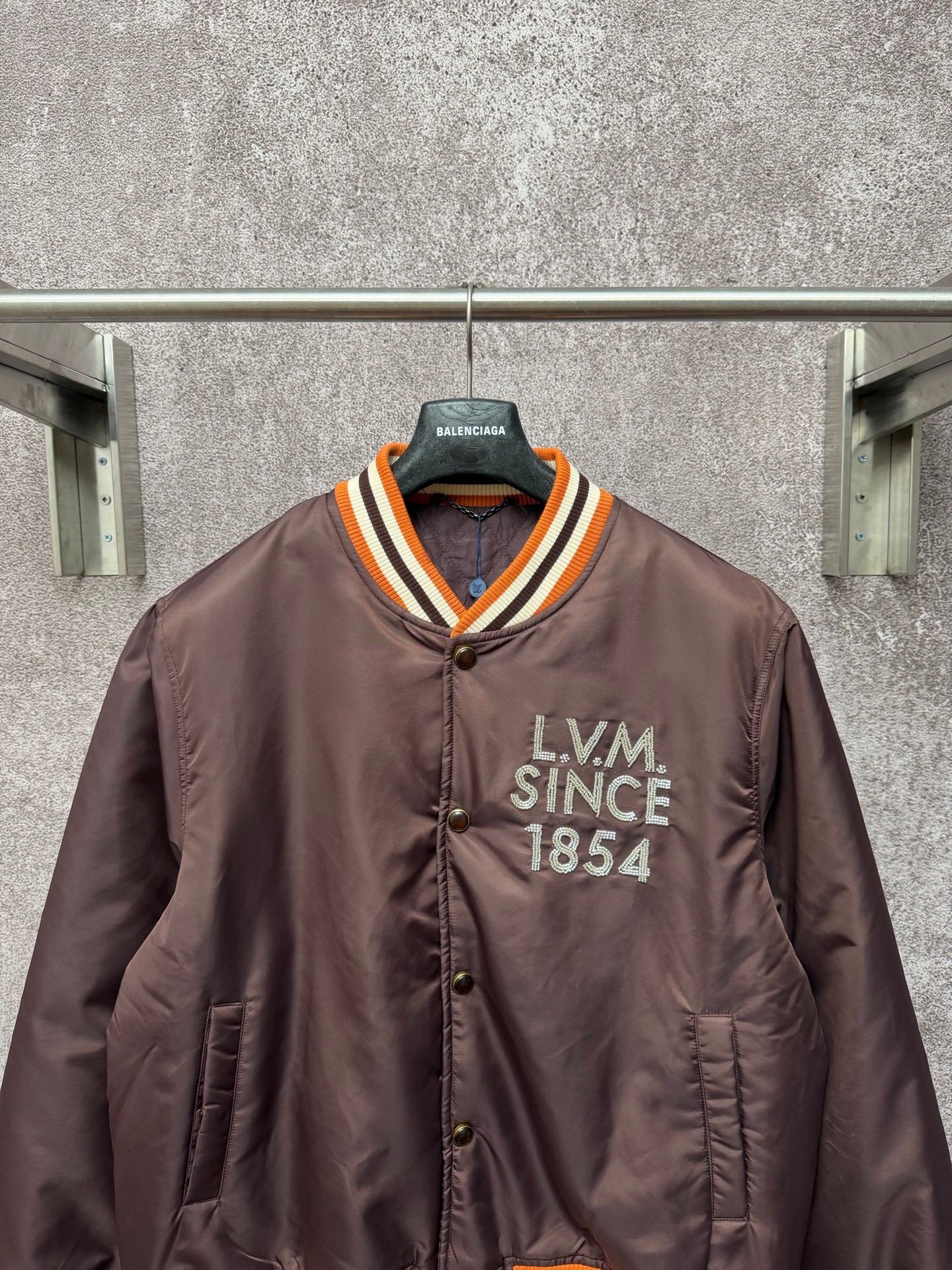 Louis Vuitton long bomber jacket, front view with LV M Since 1854 patch and striped collar