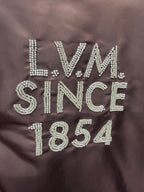 Louis Vuitton long bomber jacket close-up of LVM Since 1854 rhinestone-style logo