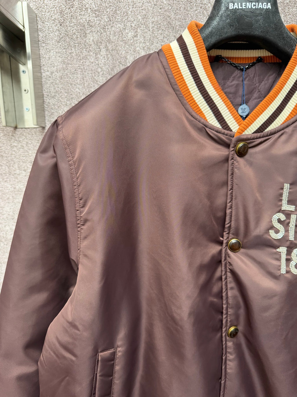 Louis Vuitton long bomber jacket with orange-striped V-neck rib collar and logo details