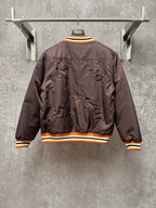 Louis Vuitton long bomber jacket, back view with raised logo and striped orange rib trim